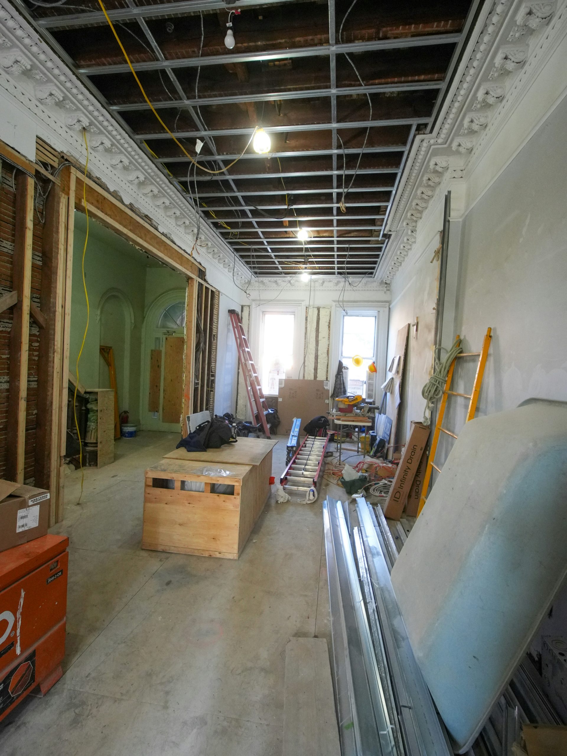 Rénovation intérieure d'une pièce avec plafond et matériaux apparents.